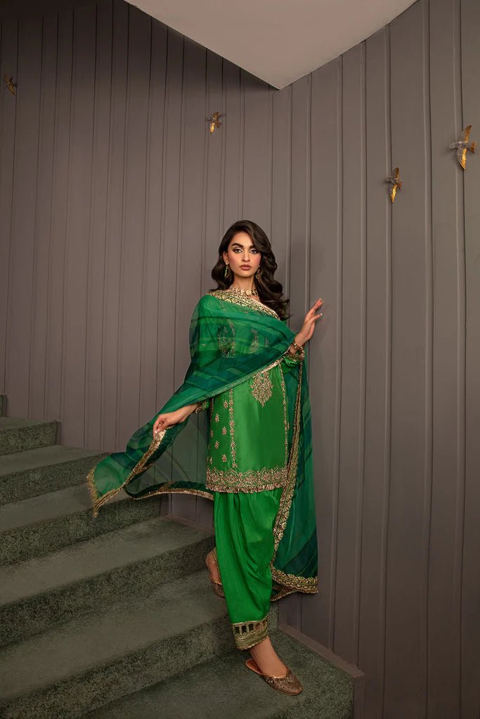 Model wearing Sobia Nazir Design 08 dress, vibrant green luxury pret, Pakistani designer wedding suit in UK.