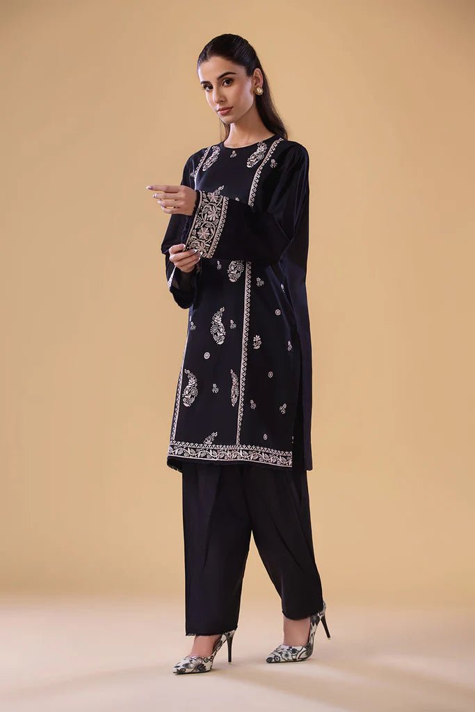 Model wearing a black SNEP - 24 - 0379 dress from Sobia Nazir's Pret '24 collection. Perfect for Pakistani clothes online in the UK.