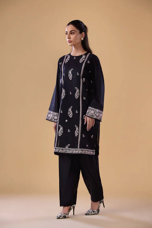 Model wearing a black SNEP - 24 - 0379 dress from Sobia Nazir's Pret '24 collection. Perfect for Pakistani clothes online in the UK.