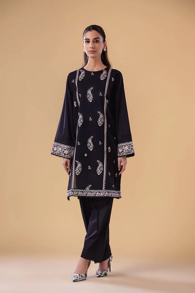 Model wearing a black SNEP - 24 - 0379 dress from Sobia Nazir's Pret '24 collection. Perfect for Pakistani clothes online in the UK.