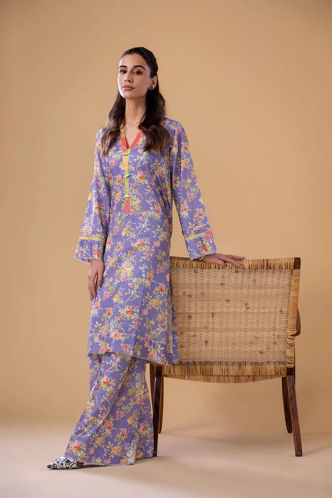 Model wearing a lavender SNPP - 24 - 0305 dress with floral print from Sobia Nazir's Pret '24 collection. Ideal for Pakistani clothes online in the UK.