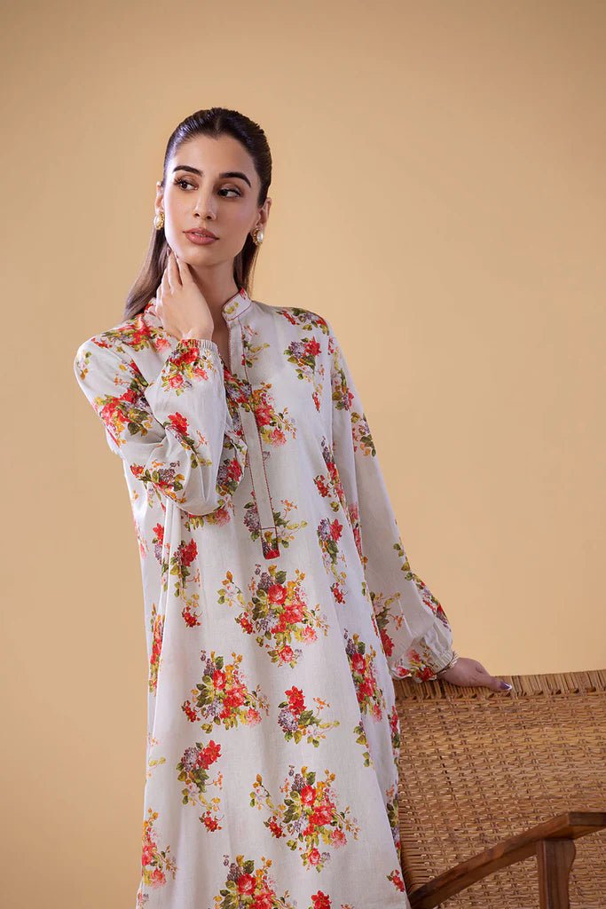 Model wearing a white dress with red and green floral print from Sobia Nazir's Pret '24 collection, SNPP - 24 - 0307. Perfect for showcasing Pakistani clothes online in the UK.