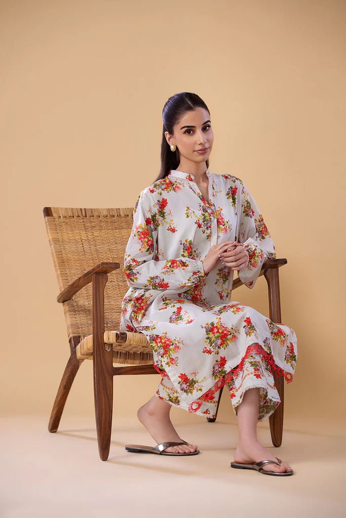 Model wearing a white dress with red and green floral print from Sobia Nazir's Pret '24 collection, SNPP - 24 - 0307. Perfect for showcasing Pakistani clothes online in the UK.