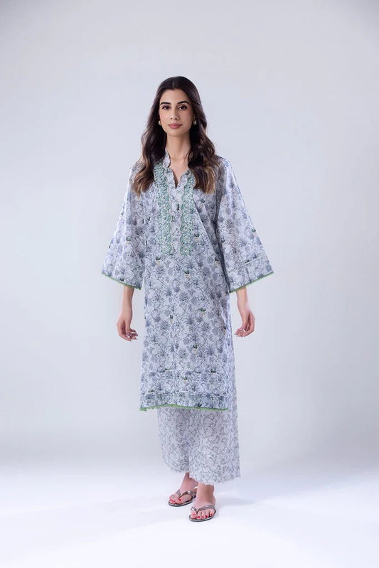 Model wearing a white and green SNPP - 24 - 0315 dress with intricate patterns from Sobia Nazir's Pret '24 collection. Ideal for Pakistani clothes online in the UK.