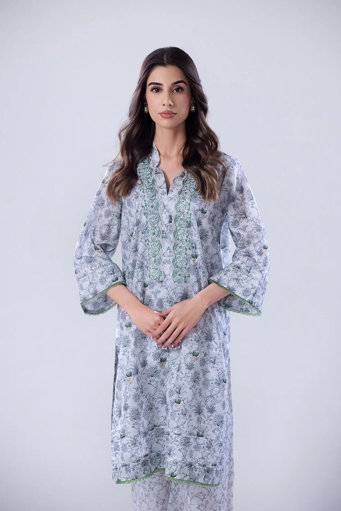 Model wearing a white and green SNPP - 24 - 0315 dress with intricate patterns from Sobia Nazir's Pret '24 collection. Ideal for Pakistani clothes online in the UK.