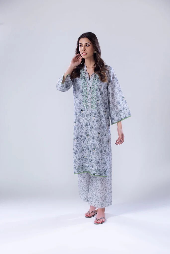 Model wearing a white and green SNPP - 24 - 0315 dress with intricate patterns from Sobia Nazir's Pret '24 collection. Ideal for Pakistani clothes online in the UK.