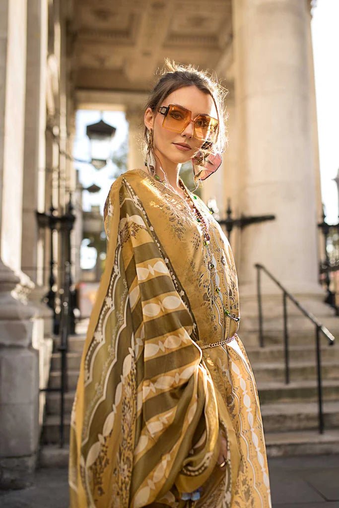 Model wearing Sobia Nazir Satin '24 Design 01, a golden and beige printed outfit with intricate patterns, perfect for winter. Available as Pakistani clothes online in the UK.