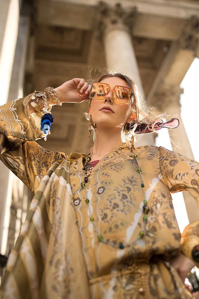 Model wearing Sobia Nazir Satin '24 Design 01, a golden and beige printed outfit with intricate patterns, perfect for winter. Available as Pakistani clothes online in the UK.