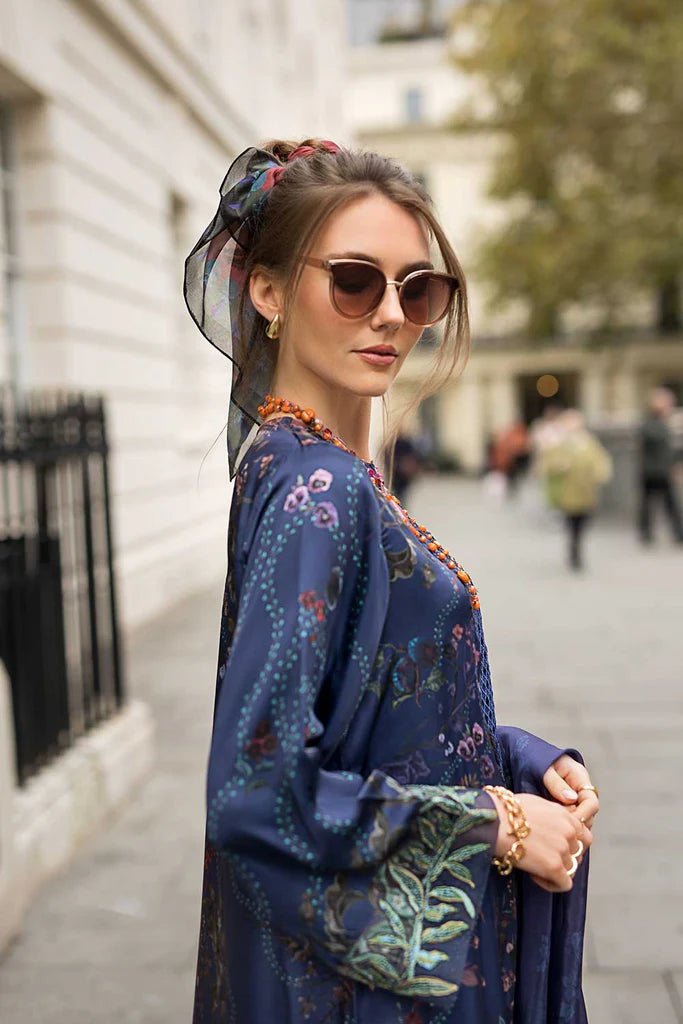 Model wearing Sobia Nazir Satin '24 Design 04, a navy blue floral printed outfit with elegant detailing, perfect for winter. Available as Pakistani clothes online in the UK.