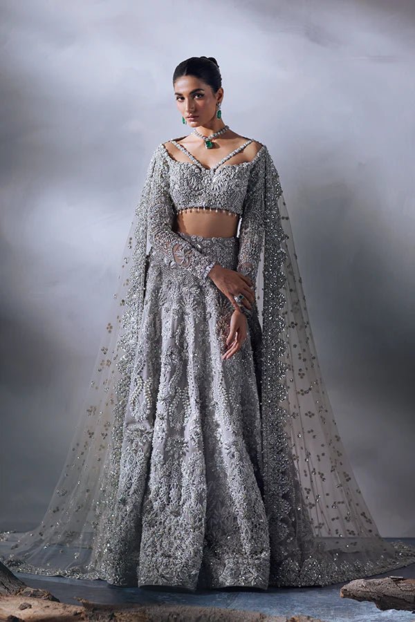 model wearing SORAYA EISLEY Pakistani bridal dress in UK, sparkling silver gown with cape