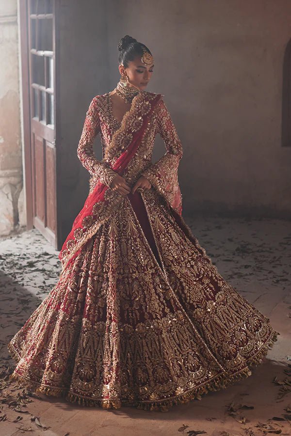 model wearing SORAYA IRIS red Pakistani bridal dress in UK, luxurious gold detailing