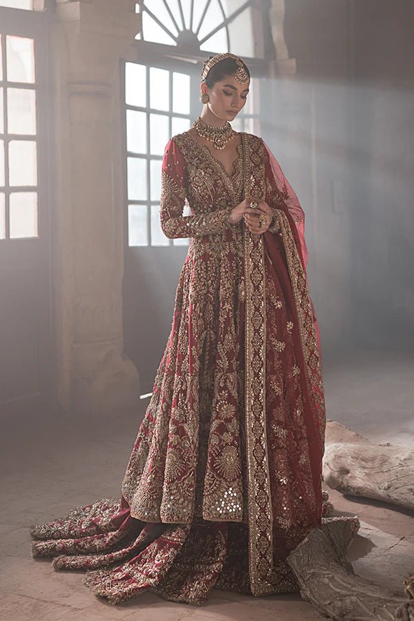 model wearing SORAYA ZOHRA Pakistani bridal dress in UK, deep red with intricate gold patterns