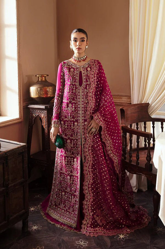 Model wearing RAIZEL dress in rich magenta from Soraya. Perfect for weddings, highlighting intricate embroidery and luxurious design. Buy Pakistani clothes online in UK from Soraya.