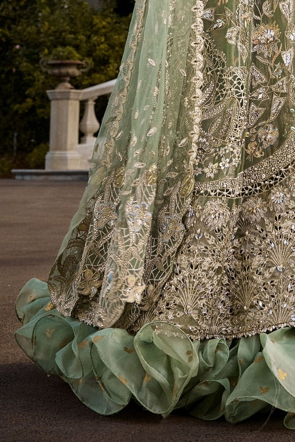 Model wearing mint green Astrid dress from Soraya, showcasing luxurious embroidery, ideal for Pakistani wedding clothes and Eid celebrations in the UK.