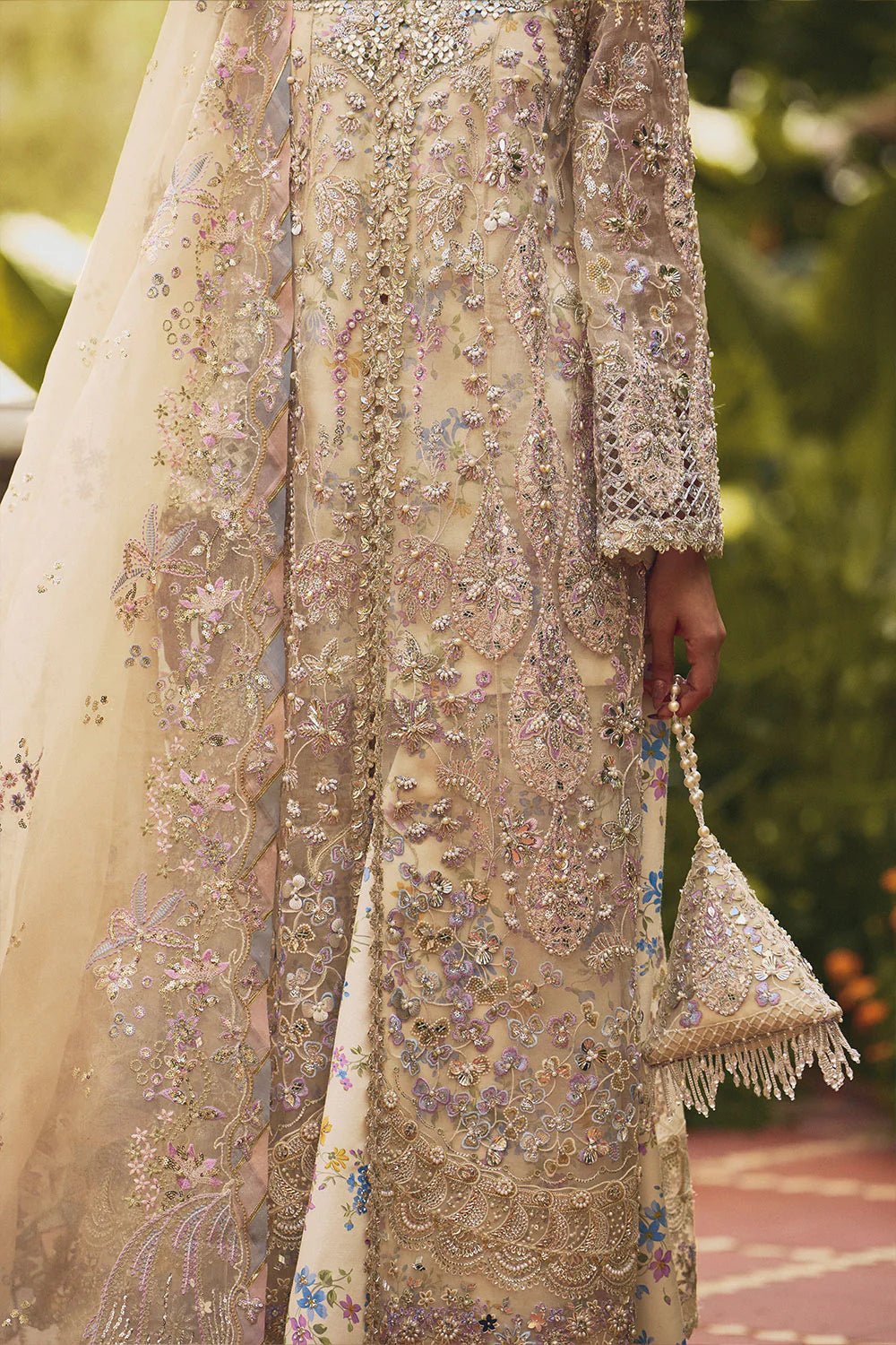 Model wearing Soraya Lumene Festive '25 Azilis dress in ivory with intricate floral embroidery and embellishments. Shop Pakistani bridal dresses online in the UK now.