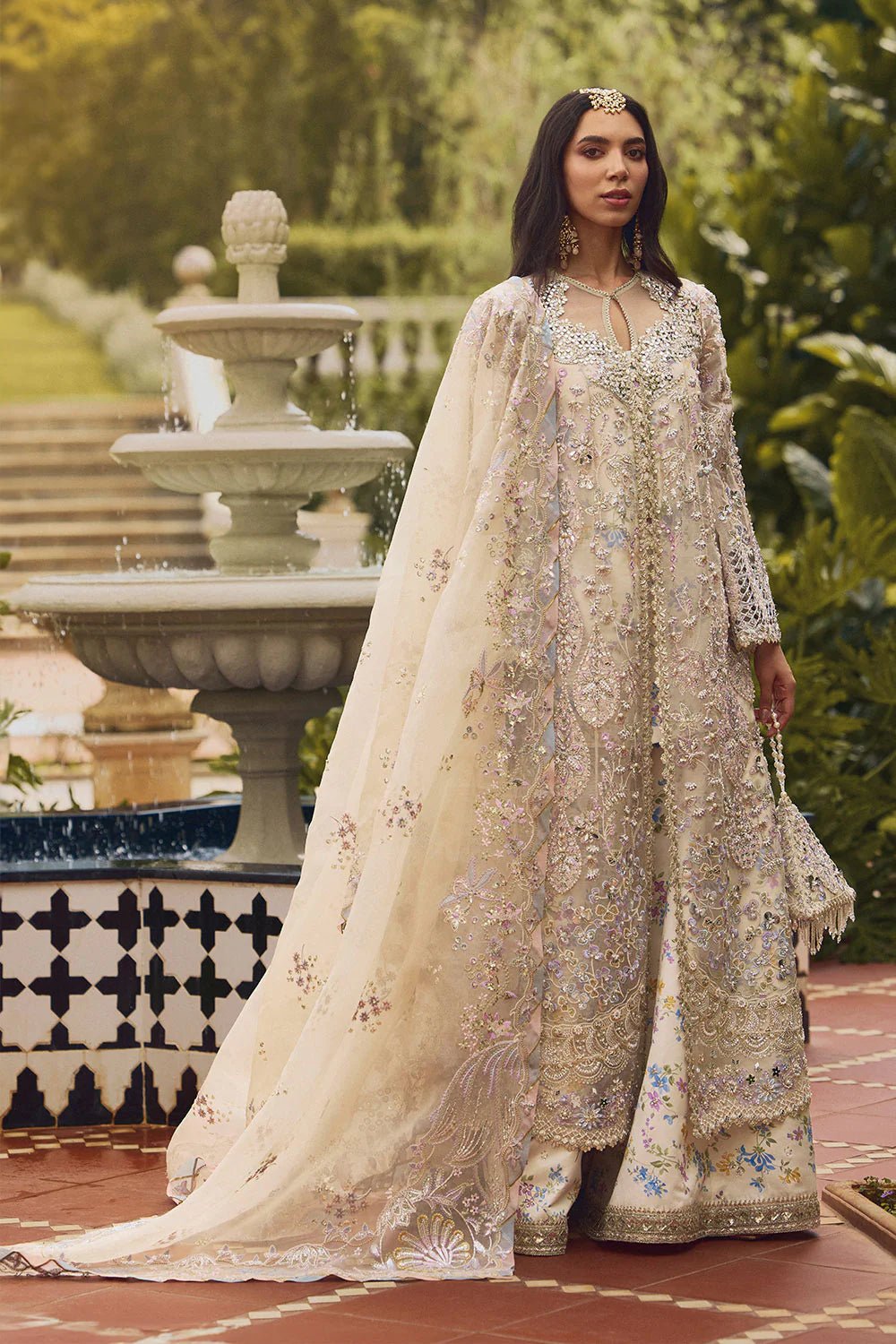 Model wearing Soraya Lumene Festive '25 Azilis dress in ivory with intricate floral embroidery and embellishments. Shop Pakistani bridal dresses online in the UK now.