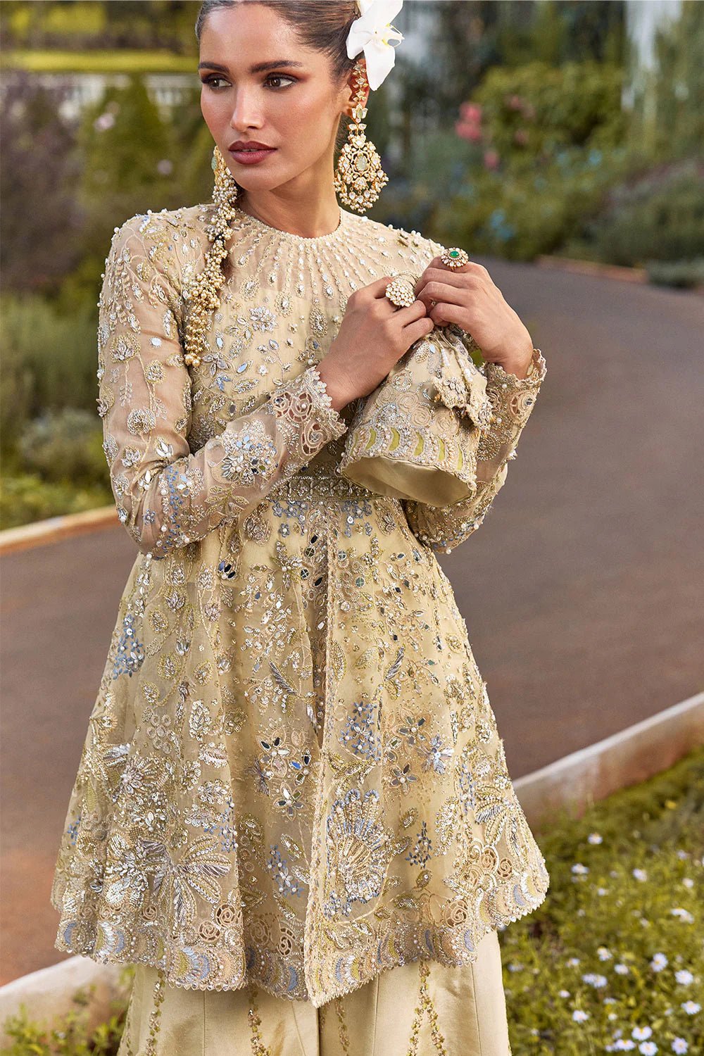 Model wearing Soraya Lumene Festive '25 Ornella dress in gold with intricate embellishments and embroidery. Shop Pakistani bridal dresses online in the UK now.