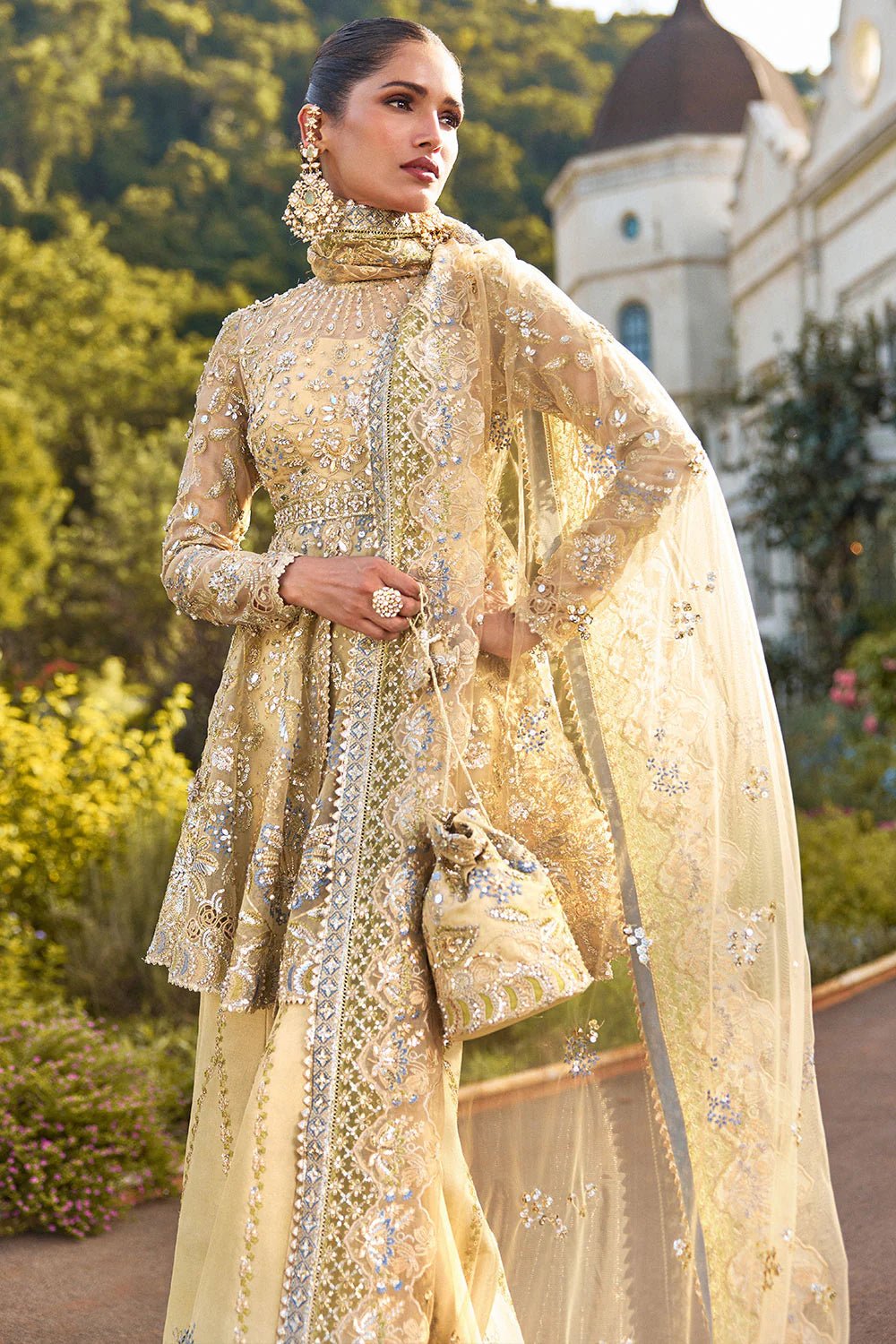 Model wearing Soraya Lumene Festive '25 Ornella dress in gold with intricate embellishments and embroidery. Shop Pakistani bridal dresses online in the UK now.