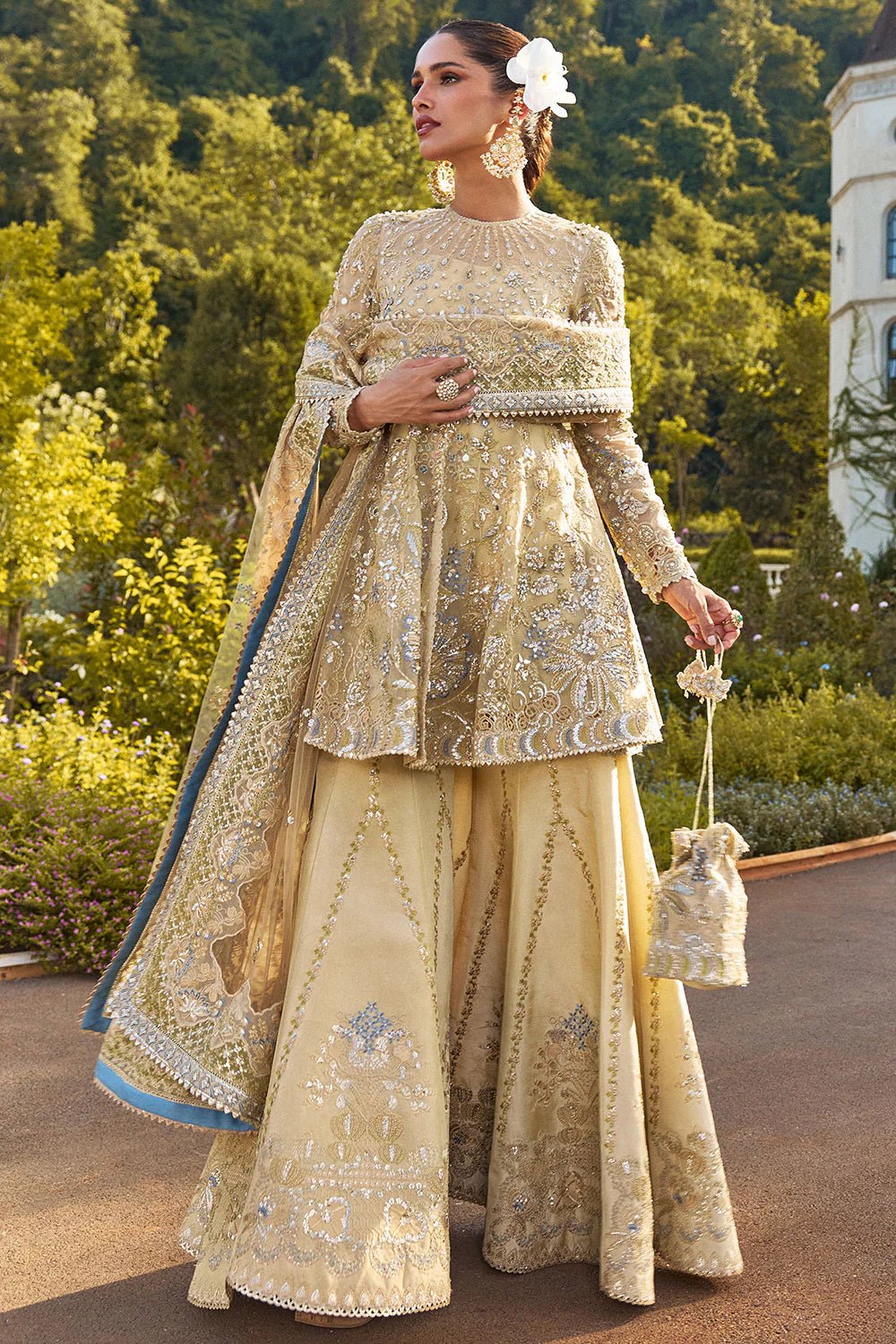 Model wearing Soraya Lumene Festive '25 Ornella dress in gold with intricate embellishments and embroidery. Shop Pakistani bridal dresses online in the UK now.