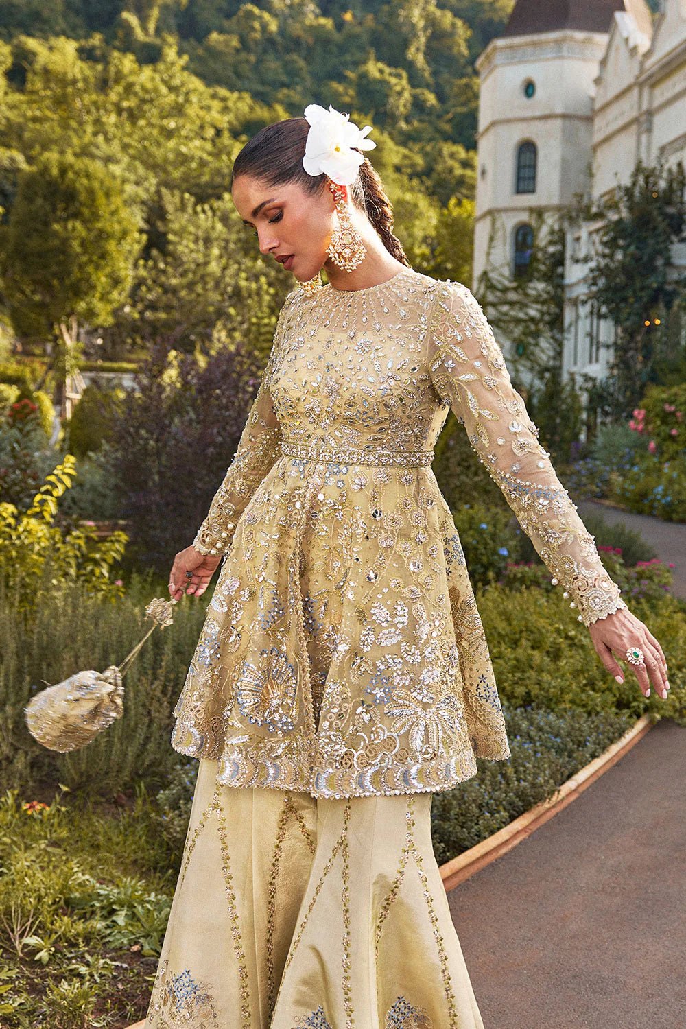 Model wearing Soraya Lumene Festive '25 Ornella dress in gold with intricate embellishments and embroidery. Shop Pakistani bridal dresses online in the UK now.