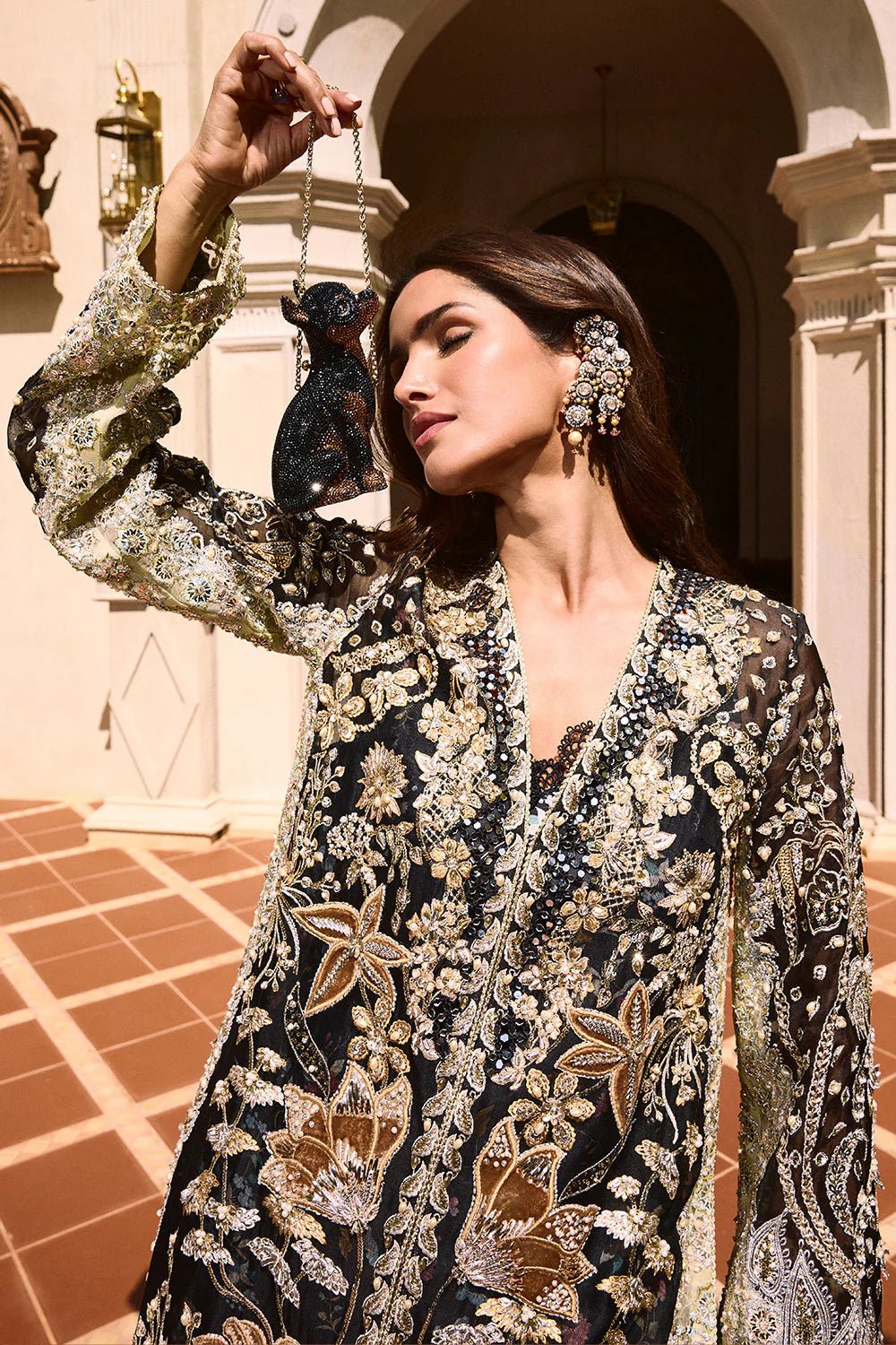 Model wearing Soraya Lumene Festive '25 Stella dress in black with intricate gold and silver embroidery. Shop Pakistani bridal dresses online in the UK now.