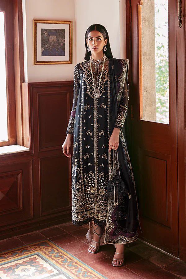 Model in Soraya Noir dress with intricate gold embellishments, a luxe Pakistani attire from the UK.