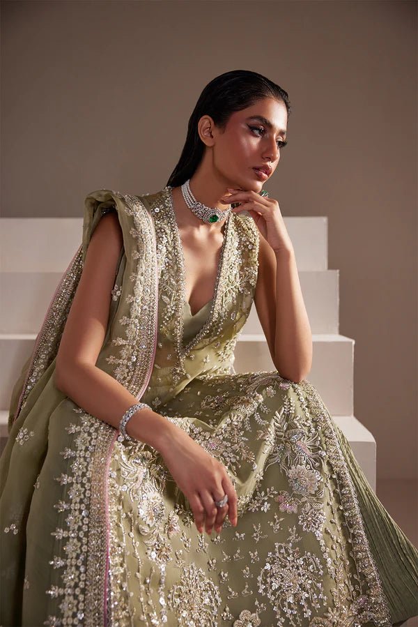 Model wearing Soraya Celeste dress in sage green from the Oriana Luxury Formals collection, ideal for weddings, available for Pakistani clothes online in the UK.