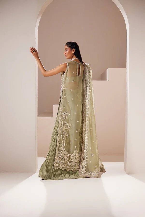 Model wearing Soraya Celeste dress in sage green from the Oriana Luxury Formals collection, ideal for weddings, available for Pakistani clothes online in the UK.