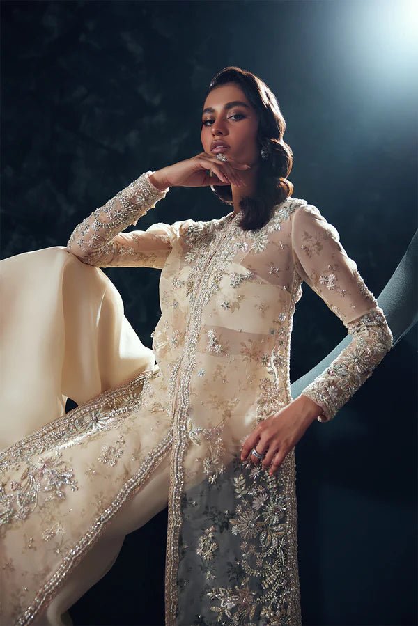 Model wearing Soraya Celestial dress in ivory from the Oriana Luxury Formals collection, perfect for weddings, available for Pakistani clothes online in the UK.