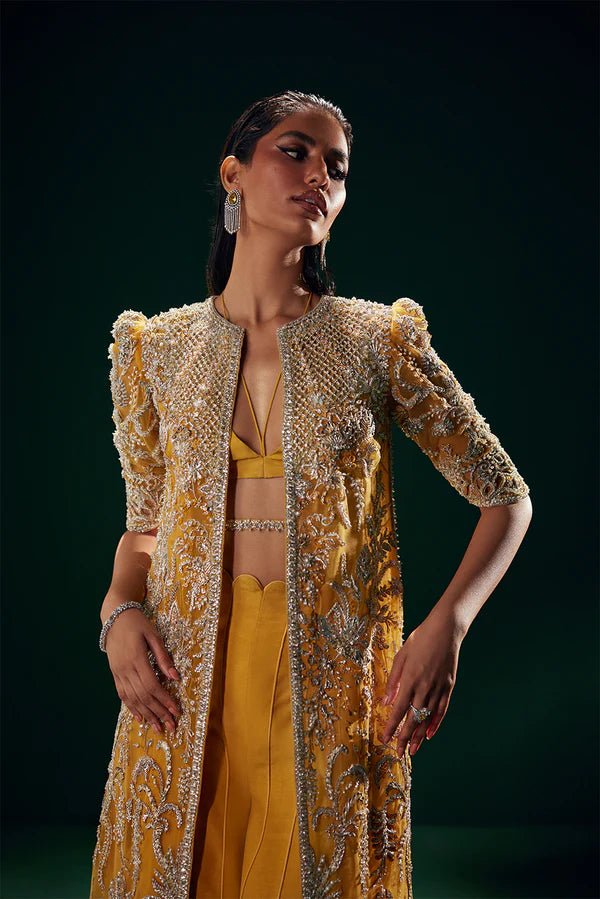 Model wearing Soraya Oriana Luxury Formals Monarch dress in yellow, showcasing intricate embroidery, ideal for Pakistani clothes online in the UK, perfect for wedding occasions.