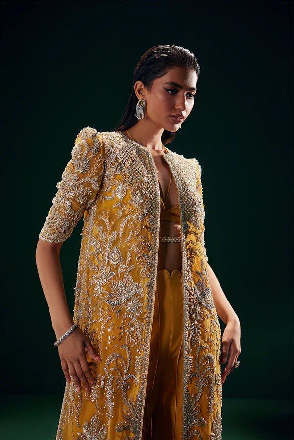 Model wearing Soraya Oriana Luxury Formals Monarch dress in yellow, showcasing intricate embroidery, ideal for Pakistani clothes online in the UK, perfect for wedding occasions.