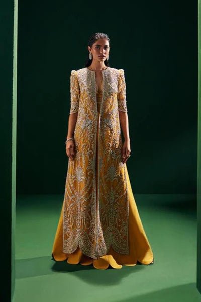 Model wearing Soraya Oriana Luxury Formals Monarch dress in yellow, showcasing intricate embroidery, ideal for Pakistani clothes online in the UK, perfect for wedding occasions.