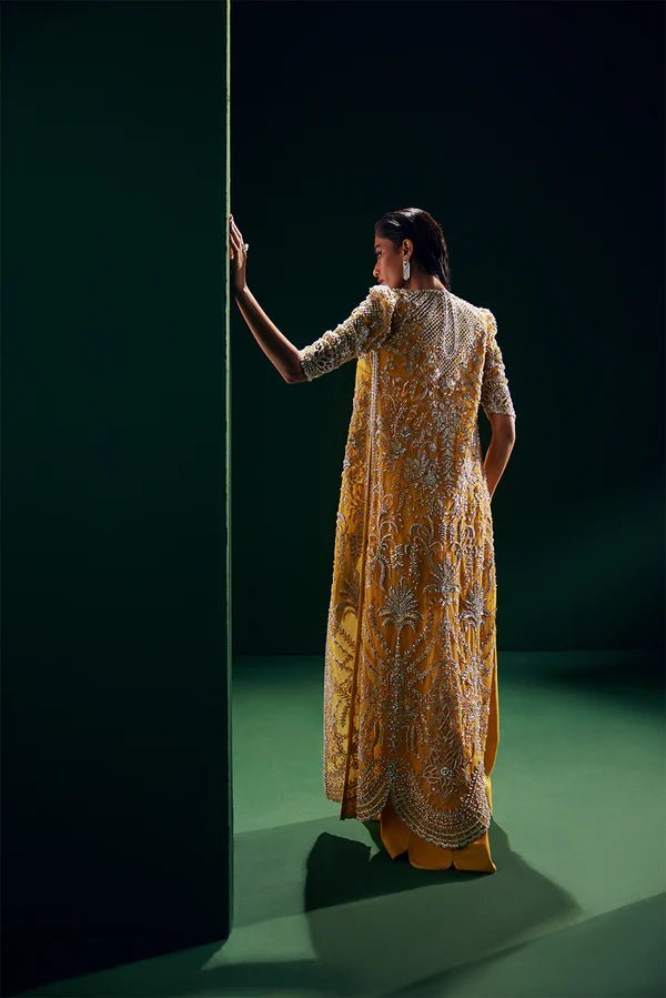 Model wearing Soraya Oriana Luxury Formals Monarch dress in yellow, showcasing intricate embroidery, ideal for Pakistani clothes online in the UK, perfect for wedding occasions.