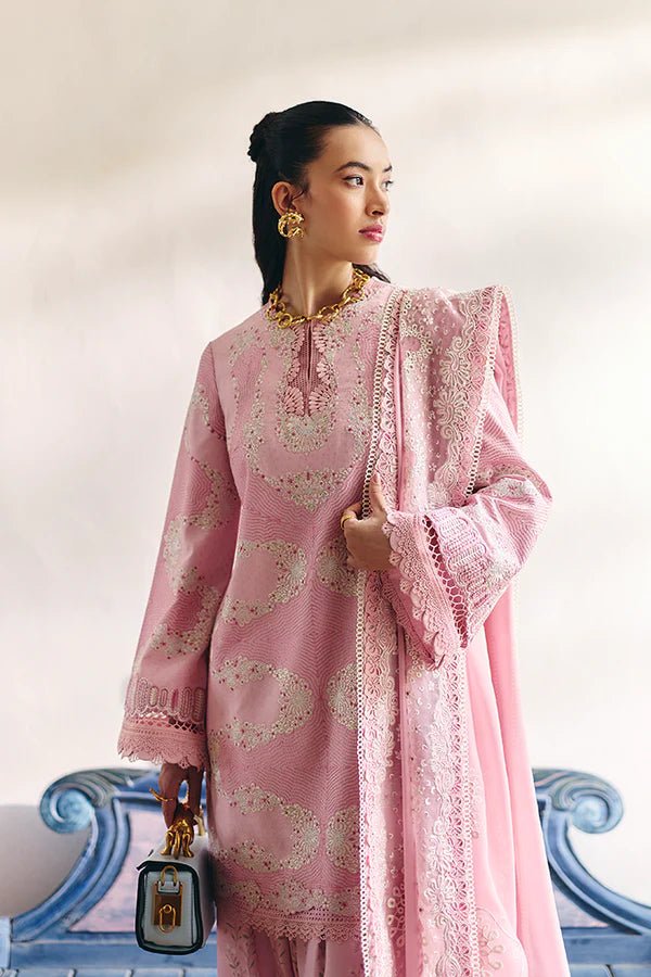 Model wearing a soft candy pink jacquard short shirt with sinuous embroidery and lace - detailed bell sleeves, paired with a wide - bottom floral print shalwar and an embroidered chiffon dupatta with organza borders. Available in the UK, brand Suffuse, Fall Casual Pret '24 collection.