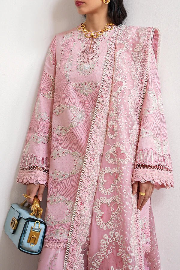 Model wearing a soft candy pink jacquard short shirt with sinuous embroidery and lace - detailed bell sleeves, paired with a wide - bottom floral print shalwar and an embroidered chiffon dupatta with organza borders. Available in the UK, brand Suffuse, Fall Casual Pret '24 collection.