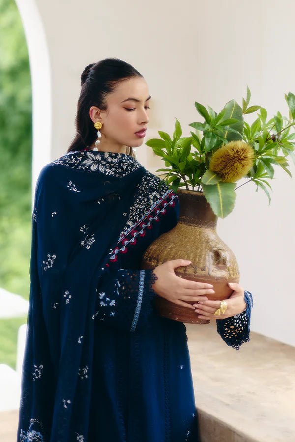 Model wearing a midnight blue jacquard outfit with bell sleeves, lace - trimmed cotton pants, and an embroidered chiffon dupatta from Suffuse Casual Pret '24.