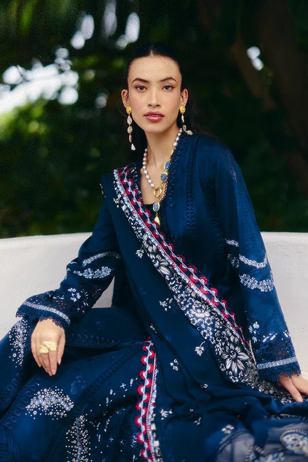 Model wearing a midnight blue jacquard outfit with bell sleeves, lace - trimmed cotton pants, and an embroidered chiffon dupatta from Suffuse Casual Pret '24.