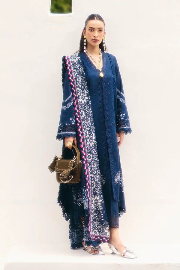 Model wearing a midnight blue jacquard outfit with bell sleeves, lace - trimmed cotton pants, and an embroidered chiffon dupatta from Suffuse Casual Pret '24.