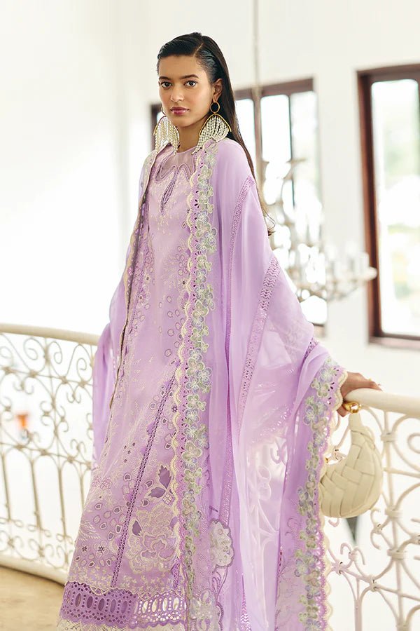 Model is wearing a lilac panelled jacquard shirt with floral embroidery, patchwork, and a crown - shaped organza neckline from Suffuse's Fall Casual Pret '24. Paired with straight cotton pants featuring lace details and cutwork finesse. The chiffon dupatta has organza borders and abstract prints. Available in the UK.