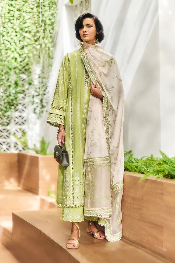 Model is wearing a parrot green jacquard kurta with organza applique, box sleeves, and intricate embroidery. Paired with matching culotte pants and a powder pink silk dupatta featuring contrasting embroidery. Available in the UK from Suffuse Fall Casual Pret '24.