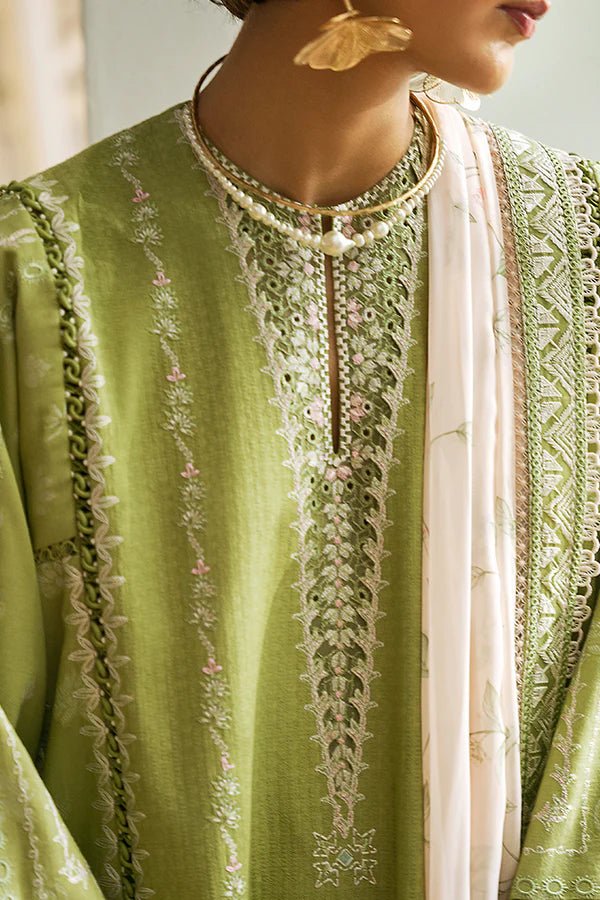 Model is wearing a parrot green jacquard kurta with organza applique, box sleeves, and intricate embroidery. Paired with matching culotte pants and a powder pink silk dupatta featuring contrasting embroidery. Available in the UK from Suffuse Fall Casual Pret '24.