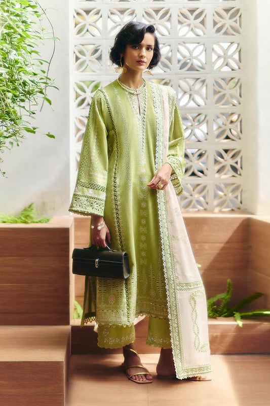 Model is wearing a parrot green jacquard kurta with organza applique, box sleeves, and intricate embroidery. Paired with matching culotte pants and a powder pink silk dupatta featuring contrasting embroidery. Available in the UK from Suffuse Fall Casual Pret '24.