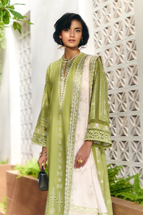 Model is wearing a parrot green jacquard kurta with organza applique, box sleeves, and intricate embroidery. Paired with matching culotte pants and a powder pink silk dupatta featuring contrasting embroidery. Available in the UK from Suffuse Fall Casual Pret '24.