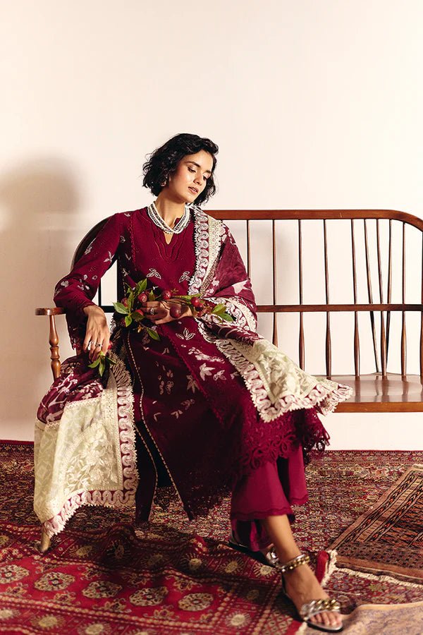 Model wearing Wine red pure cotton jacquard kurta with contrasting embroidery and a layered crew neck. Bell sleeves with lacework. Paired with cotton culottes and a printed silk dupatta with green borders from Suffuse Casual Pret '24.