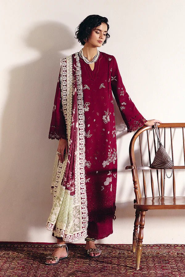 Model wearing Wine red pure cotton jacquard kurta with contrasting embroidery and a layered crew neck. Bell sleeves with lacework. Paired with cotton culottes and a printed silk dupatta with green borders from Suffuse Casual Pret '24.