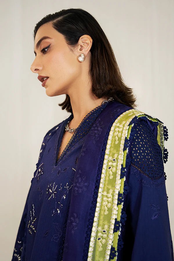 Model in a Suffuse Casual Pret '24 outfit featuring an indigo blue cotton jacquard shirt with cutwork details, paired with matching pants and a dual - color organza dupatta.