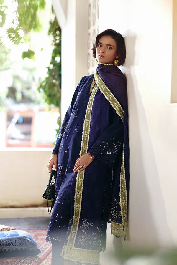 Model in a Suffuse Casual Pret '24 outfit featuring an indigo blue cotton jacquard shirt with cutwork details, paired with matching pants and a dual - color organza dupatta.