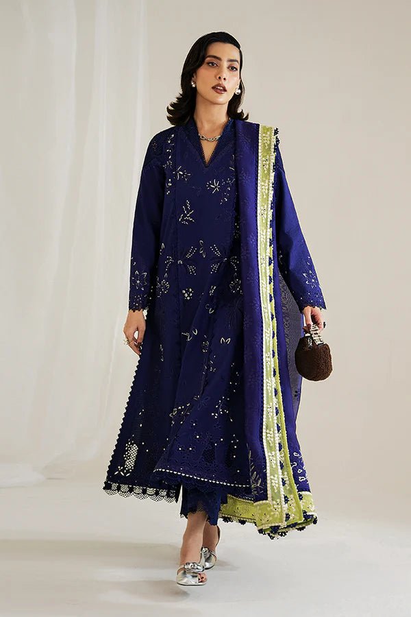 Model in a Suffuse Casual Pret '24 outfit featuring an indigo blue cotton jacquard shirt with cutwork details, paired with matching pants and a dual - color organza dupatta.