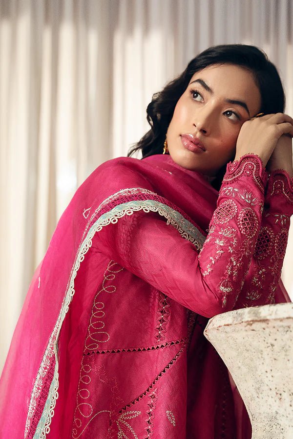 Model wearing a coral pink front open jacquard shirt with intricate lacework, embroidered straight cotton pants, and an organza dupatta featuring ice blue contrasting borders from Suffuse Casual Pret '24.