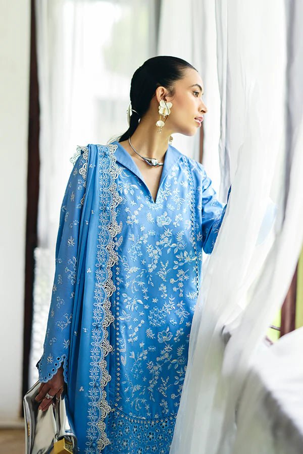 Denim blue pure cotton jacquard shirt with floral embroidery, scalloped bell sleeves, and lace detailing. Paired with embroidered off - white culotte pants and a chiffon dupatta featuring embroidered borders and tassels. Available in the UK, brand Suffuse, Casual Pret '24 collection.